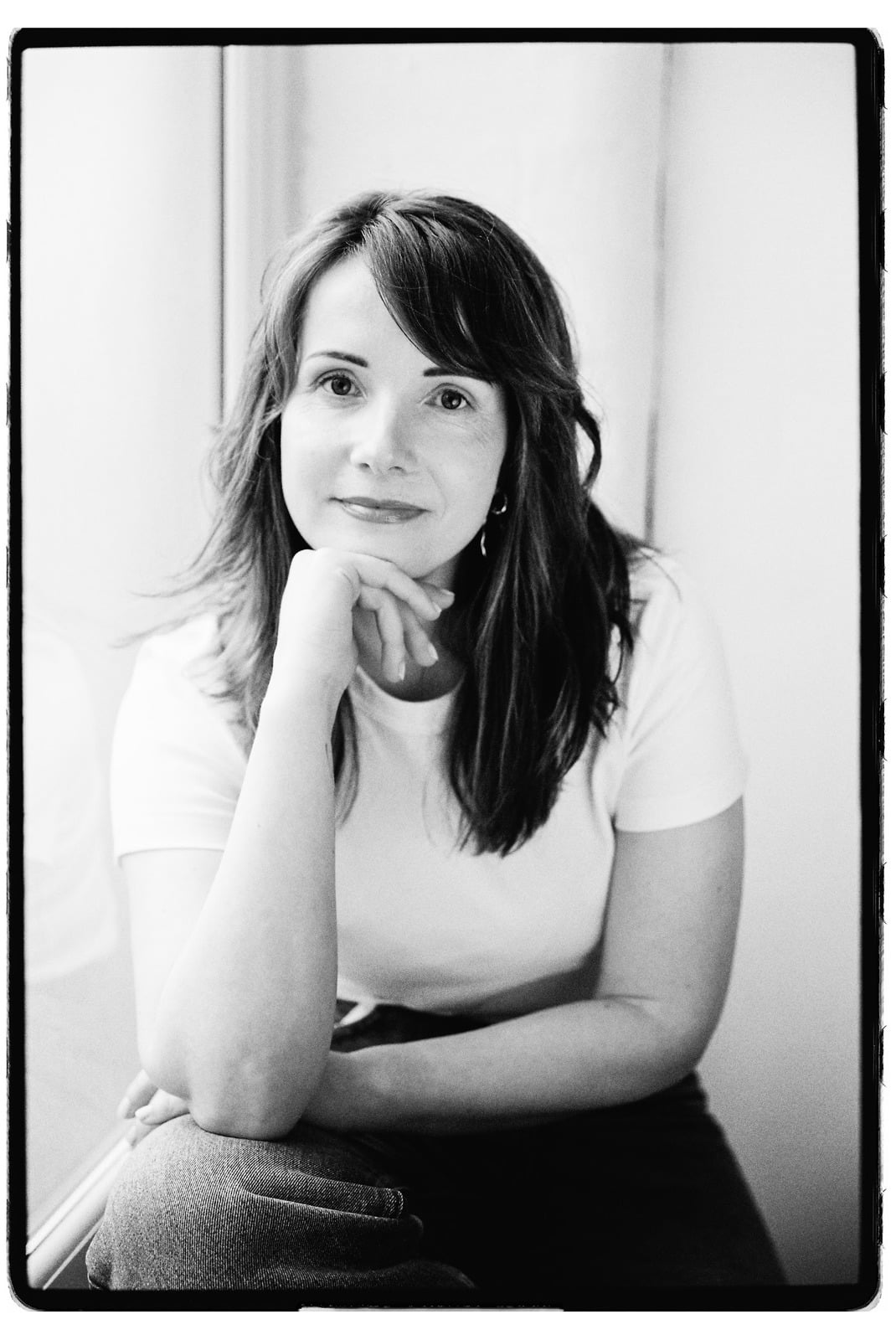 Laura McDermott resting her chin on her hand, in a thoughtful, reflective moment